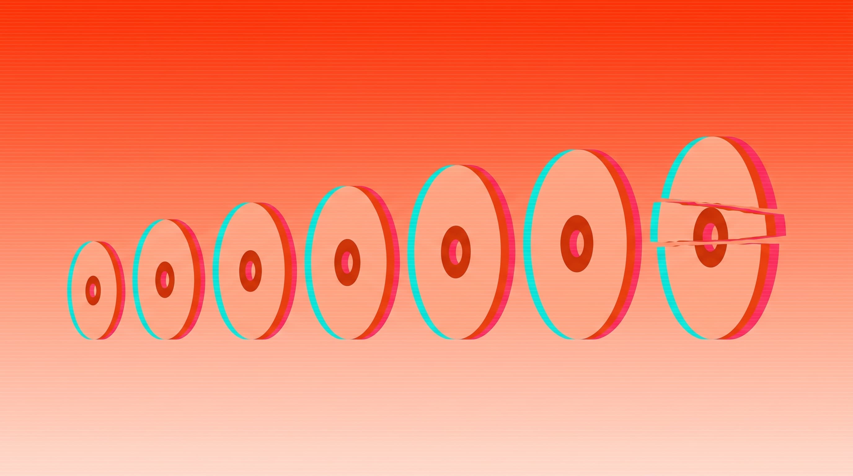 A row of discs growing steadily larger from left to right, the last one splitting apart.